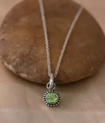 925 sterling silver peridot pendant with round cut gemstone and handcrafted rawa work border