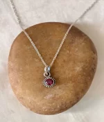 925 sterling silver garnet rawa pendant with round faceted gemstone and handcrafted silver beaded border