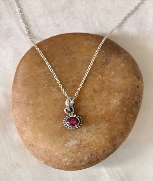 Garnet Rawa Pendant by Shriha 925 sterling silver garnet rawa pendant with round faceted gemstone and handcrafted silver beaded border